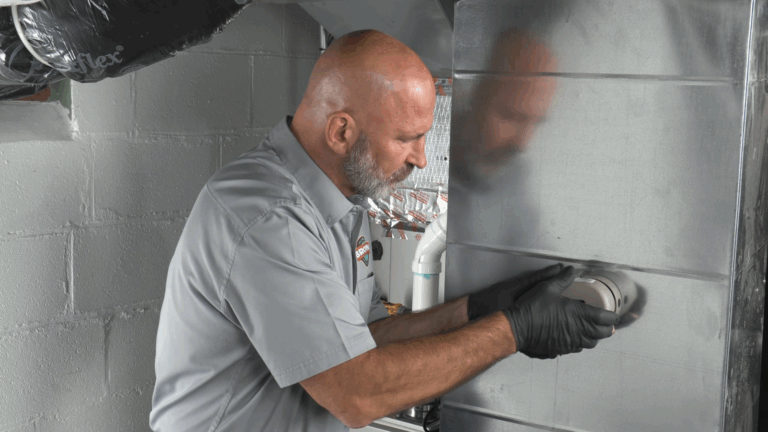 A Brown Cooling and Plumbing licensed HVAC Technician in Palmetto performs HVAC maintenance on an HVAC system in Palmetto, Florida